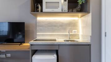 A modern kitchen with a microwave, sink, and built-in dishwasher.
