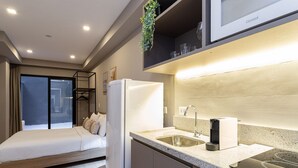 A modern kitchen with a built-in oven, a refrigerator, and a sink.