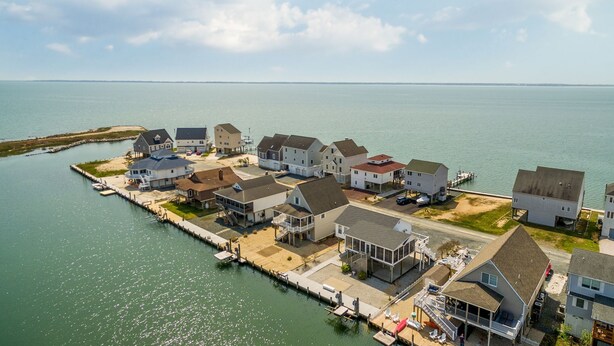 A coastal residential area with houses connected by a dock.