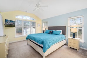 A bedroom with a bed, a nightstand, a dresser, a ceiling fan, and a window with blinds. - The Sweets Spot by Seaside Vacations & Sales (Greenbackville)
