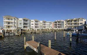 A waterfront property with multiple multi-story buildings, docked boats, and a wooden pier.