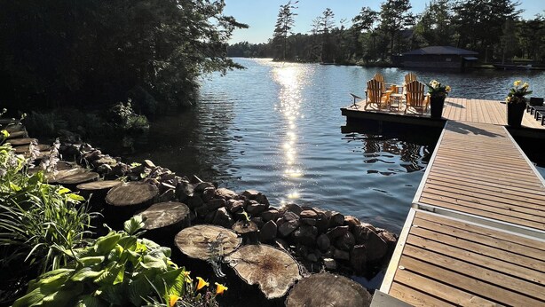 A wooden dock extending into a calm lake, surrounded by dense trees and a clear sky. - Enjoy Beautiful Sunrise & Sunset in Your Private Island Paradise (Duoro-Dummer)