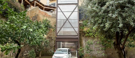 A car parked in a courtyard with a building in the background.