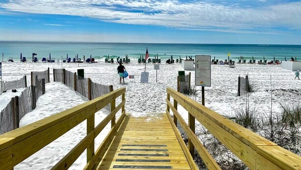 A wooden boardwalk leading to a beach with a clear sky and ocean view. - Beachfront |Pool, Games, No Stairs! Sleeps 12 (Destin)