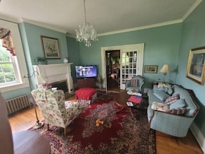 Cozy living room with a fireplace, TV, and comfortable seating.