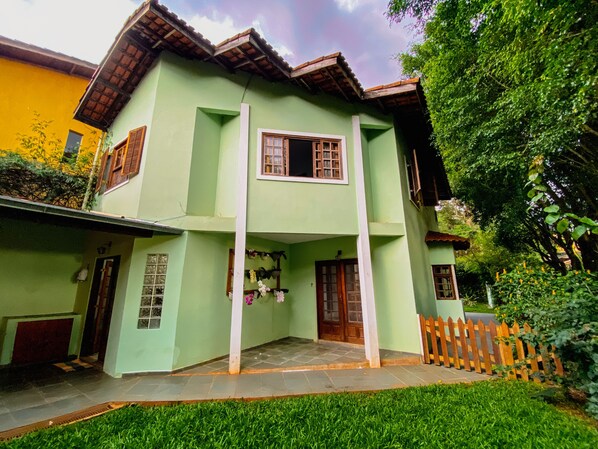 Stunning two-story building with a central entrance and lush garden area.