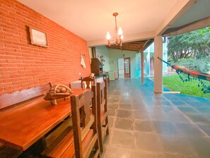 Relax in a serene space with a high ceiling, chandelier, and comfortable seating area.