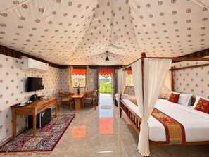 A room with a bed, a desk, a chair, and a television. - Vasant Vihar Resort (Garudeshwar)