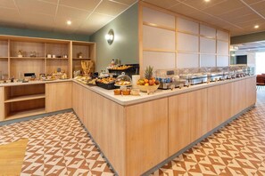 A breakfast bar with various food items and a fruit bowl. - Sure Hotel by Best Western Caen Memorial (Caen)