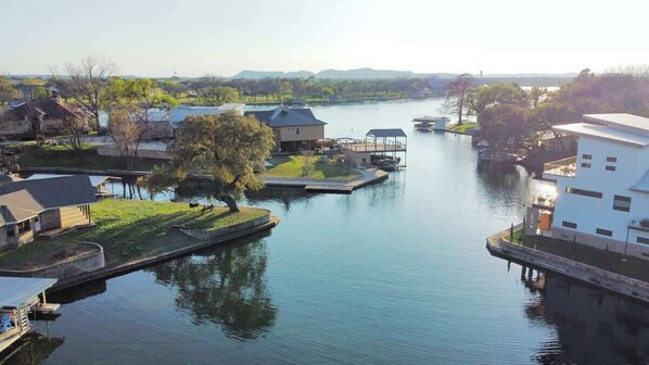 A riverside property with a dock, a house, and a boat.