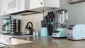 A kitchen with a microwave, kettle, toaster, blender, and knife block. - Valley Views Apartment  (Happy Valley)