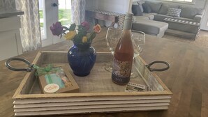 A wooden tray with a blue vase, a bottle, and a framed picture on a wooden table. - Templeton Vineyard Farmhouse in the Heart of Wine Country  (Templeton)
