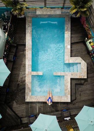 Outdoor pool, open 9:00 AM to 9:00 PM, pool umbrellas
