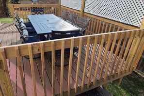 A wooden deck with a table and chairs. - Game Room/Big TVs King Beds -4 Min to Finley Farms (Ozark)