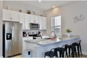 Enjoy cooking in this well-equipped kitchen with a refrigerator, microwave, and oven.