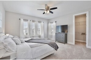 Cozy retreat with a single bed, flat-screen TV, and walk-in closet.