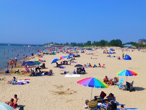 A crowded beach with numerous umbrellas and people. - Brand new St Joseph Marina Resort House with POOL! (St. Joseph)