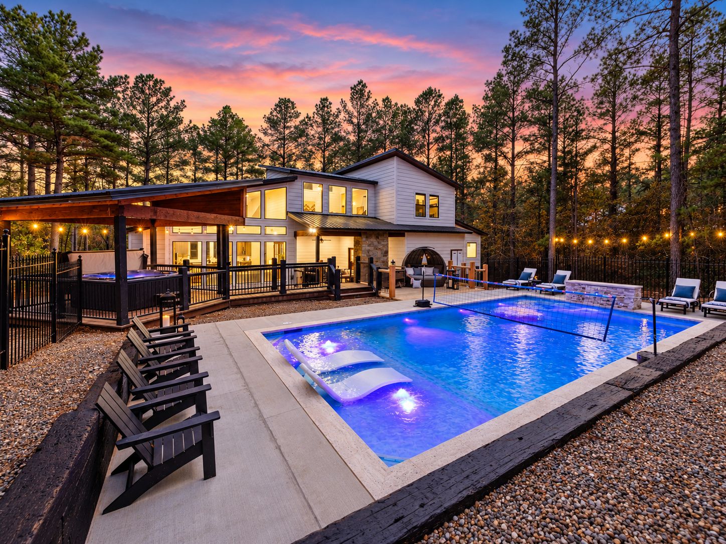 A residential property with a swimming pool, outdoor seating, and a covered patio area.