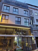 Un hotel moderno con fachada de vidrio, un cartel que dice "CASA CITY Break" y un balcón con barandilla.