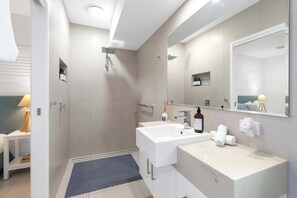 A modern bathroom with a walk-in shower, two sinks, and a large mirror. - The Last Resort - Villa 1 (Palm Cove)