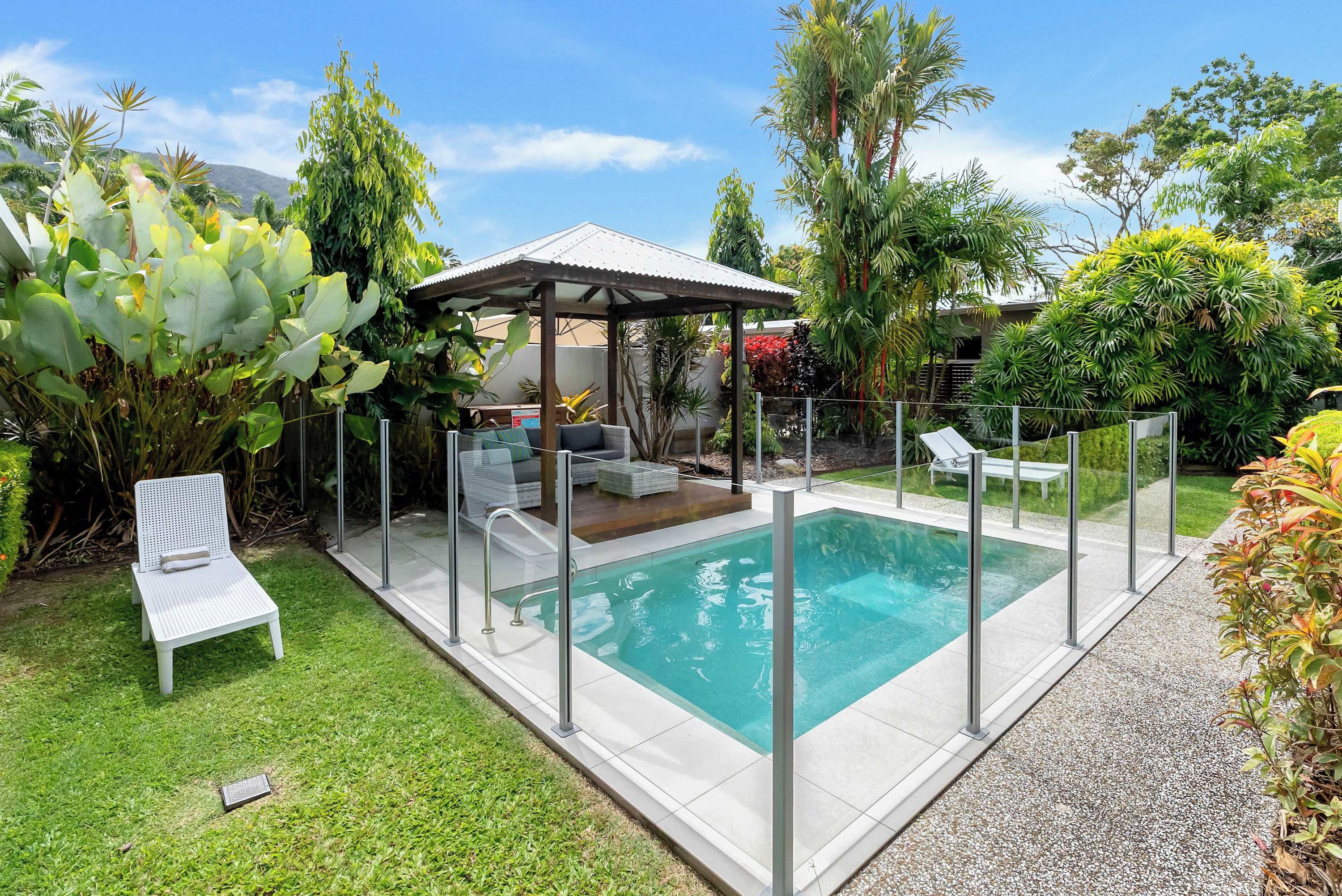 The shared pool area offers a tropical retreat, complete with sun loungers, a shaded cabana and comfortable outdoor seating for relaxing between swims.