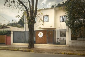 A two-story building with a gated entrance, a visible logo, and a number 0314 on the wall. - Hotel Boutique Lambassade Bellavista (Santiago)