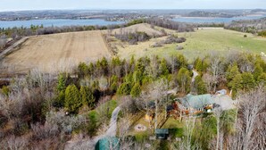 A large, open property with a main house, a guest house, and a fenced yard.