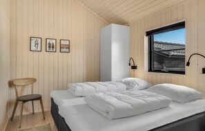 A bedroom with a bed, a chair, and three framed pictures on the wall. - Pet friendly home in Hjørring with WiFi (Hjørring)