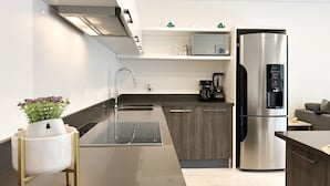 A modern kitchen with stainless steel appliances, a built-in oven, and a coffee maker. - Lovely condo w/private pool, 3 min from the beach! (Playa del Carmen)