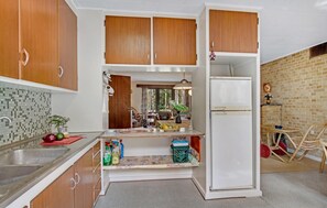 Fridge, stovetop, dishwasher, coffee/tea maker