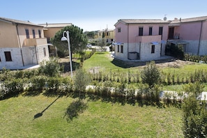 A residential area with houses, a lawn, and a street lamp.