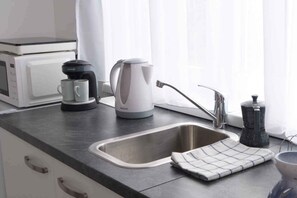 Fridge, microwave, stovetop, coffee/tea maker