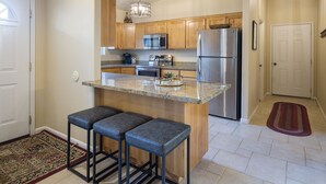 A modern kitchen with wooden cabinets, stainless steel appliances, and a granite countertop. - New Listing: Private Spa | Sunroom | Pool | Garage | Close to Parks | C347 (Moab)