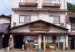 A two-story building with a signboard above the entrance.
