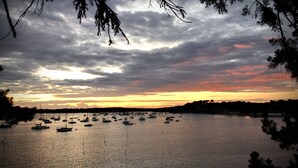 A marina with multiple boats anchored in calm waters during sunset. - Quiet studio in the heart of Arradon (Arradon)