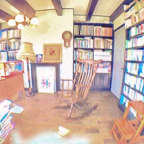 A library interior with bookshelves, a wooden chair, a desk, and a lamp. - British Country House Brookfield Farm (Nasu)