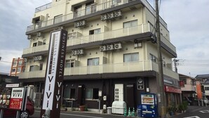 Un edificio de varios pisos con un letrero que dice 'ViVi Business Hotel'.