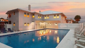A two-story house with a swimming pool, a covered patio, and a fenced yard. - Steps to the Beach | King Beds | Pool Access (Tybee Island)