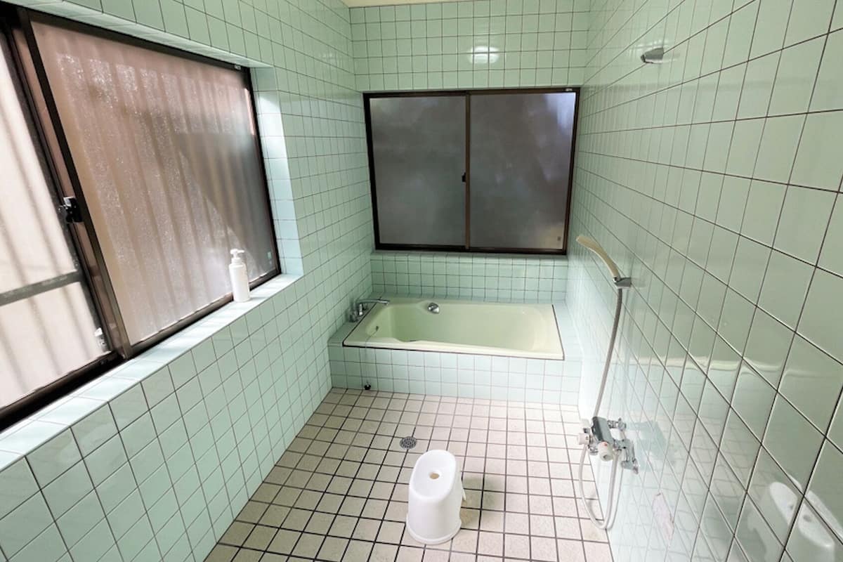 A small bathroom with a toilet, a sink, and a bathtub.