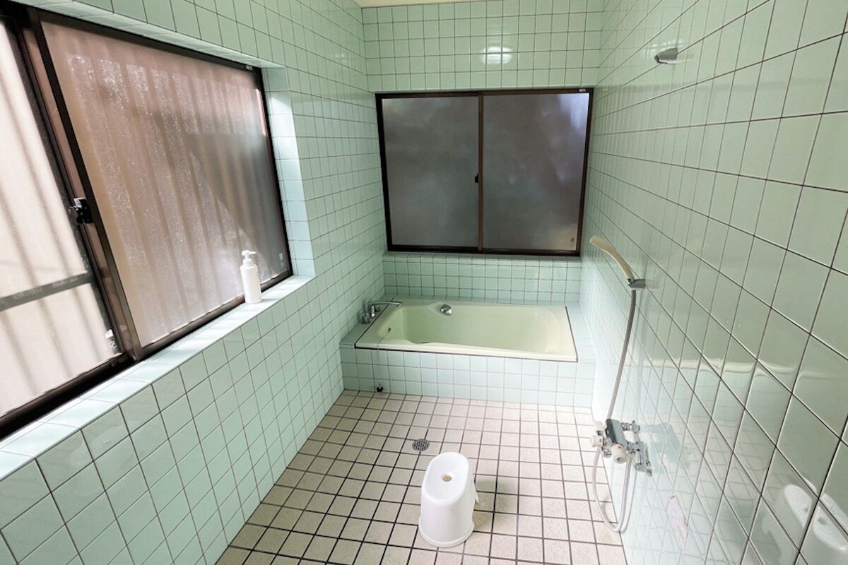 A small bathroom with a toilet, a sink, and a bathtub.