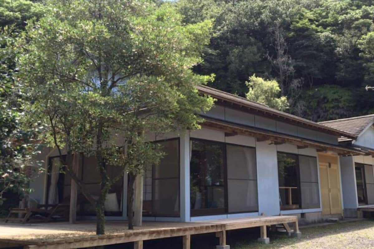 A traditional Japanese-style building with large windows and a wooden deck.