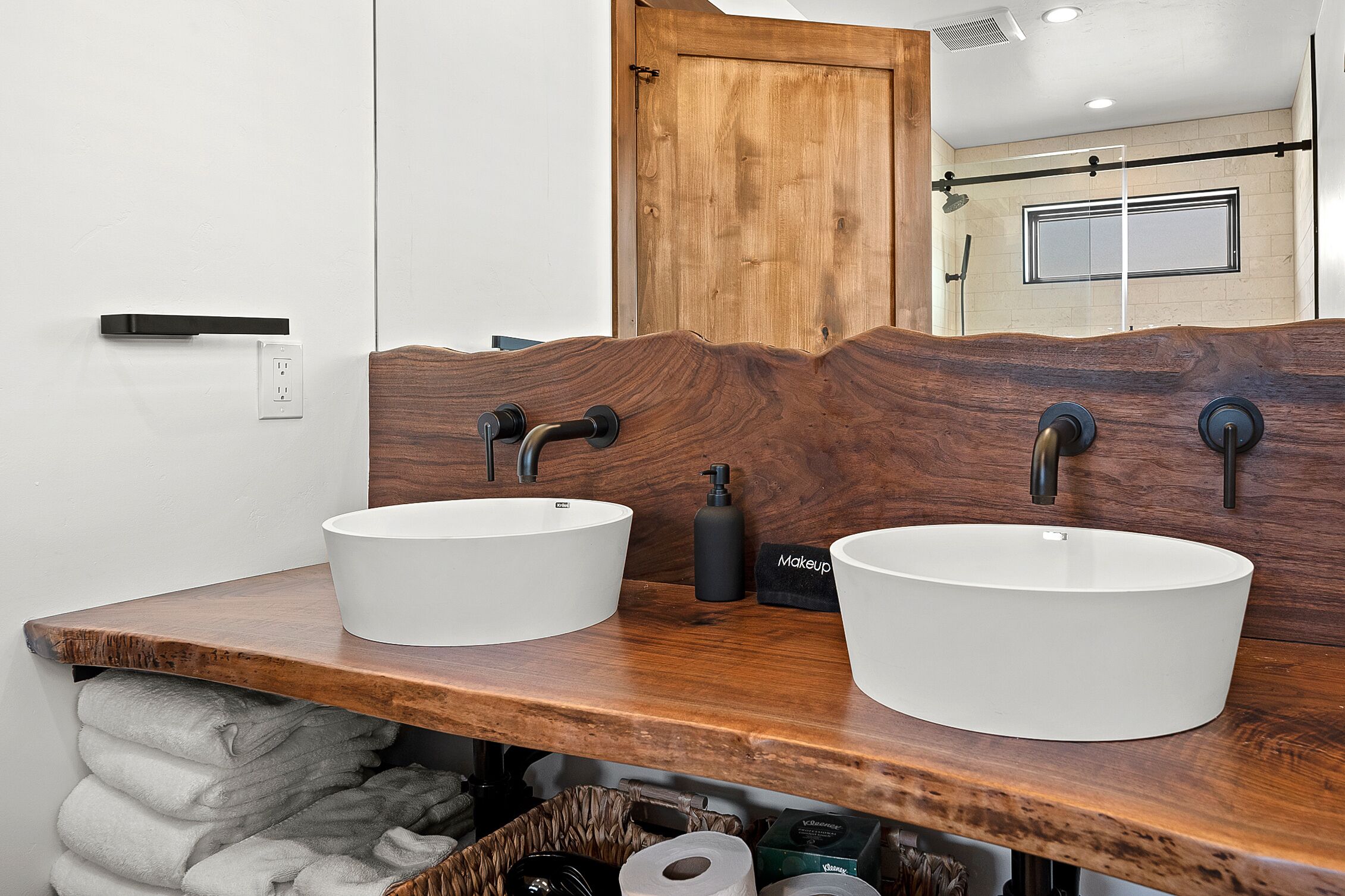 Master bathroom located on the lower level of the cabin. It is a well-appointed space designed for relaxation and comfort.