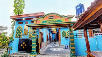 A colorful entrance with a sign reading 'Rumah Inap'.