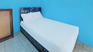 A single bed in a room with blue walls and a patterned headboard. - Spot On 91811 Rumah Inap Bunda Nurhayati (Tanak Awu)