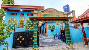 A colorful building with a sign reading "Rumah Inap."