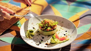 A plate of food with a fork and knife on a colorful tablecloth. - Maison Daouia (Marrakech)