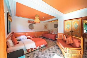 Een kamer met twee bedden, een bank en een kast.