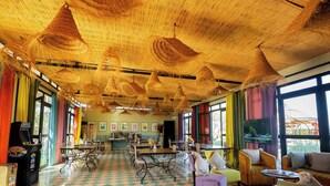 A spacious room with a checkered floor, a bar area, and a seating area with sofas and chairs. - Maison Daouia (Marrakech)