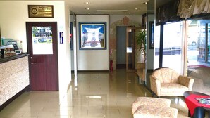 A hotel lobby with a reception desk, seating area, and a large framed picture on the wall. - Hotel Shimizuso (Sakura)