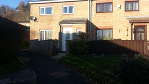 A two-story residential building with a brick facade, a front door, and a small front yard with a pathway leading to the entrance. - House - Sleeps 5 - Pets Ok - Parking - Garden (Bristol)